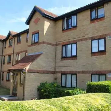 Three-story apartment building in Enfield where Warm & Cosy replaced old heaters.