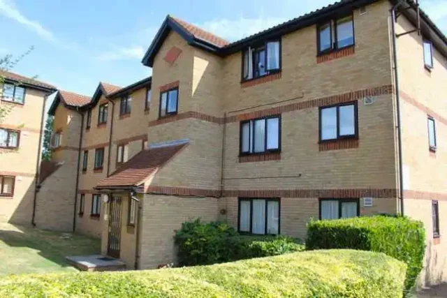 Three-story apartment building in Enfield where Warm & Cosy replaced old heaters.